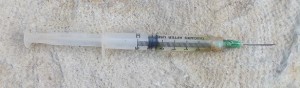 Plastic syringe and metal needle.
