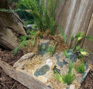 Fun Diorama with Fossilized Dinosaur Bones, toys, and bits of plastic plants make up this fun project.